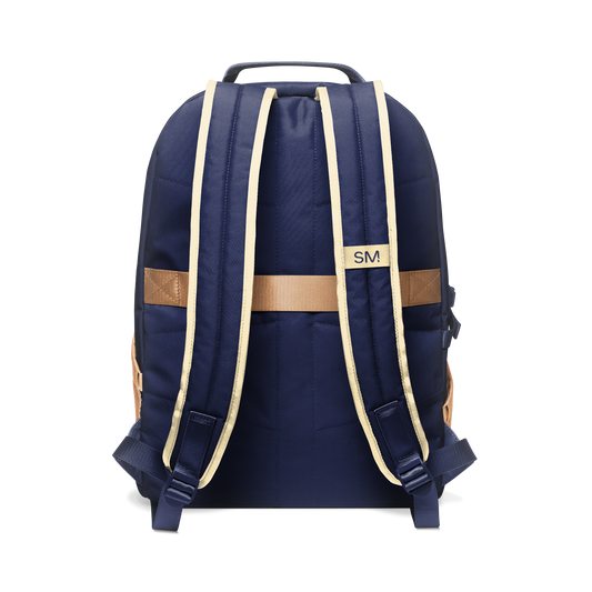 Navy blue backpack with tan and cream shoulder straps and handles