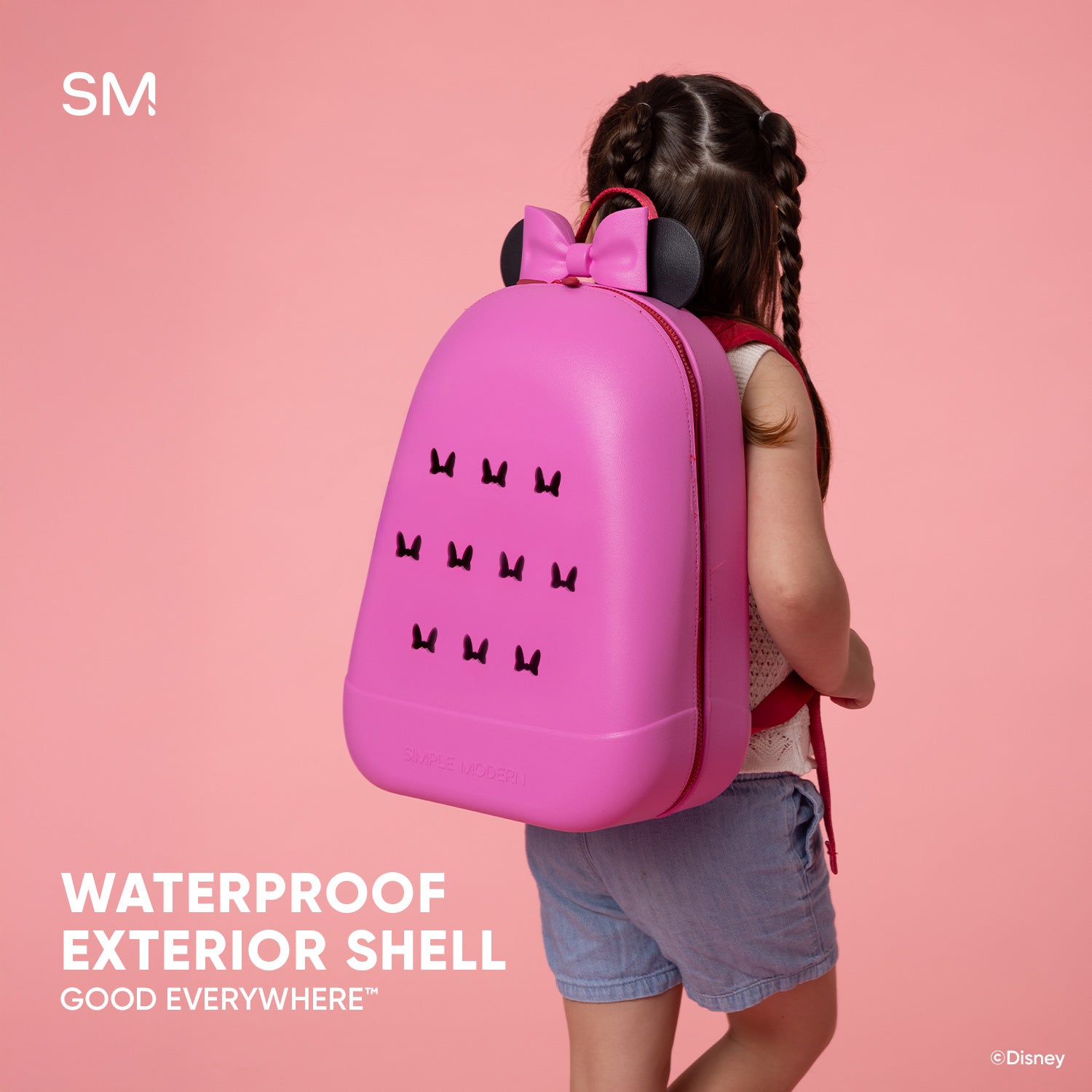 Hot pink Disney kids backpack with waterproof shell displayed against soft pink background